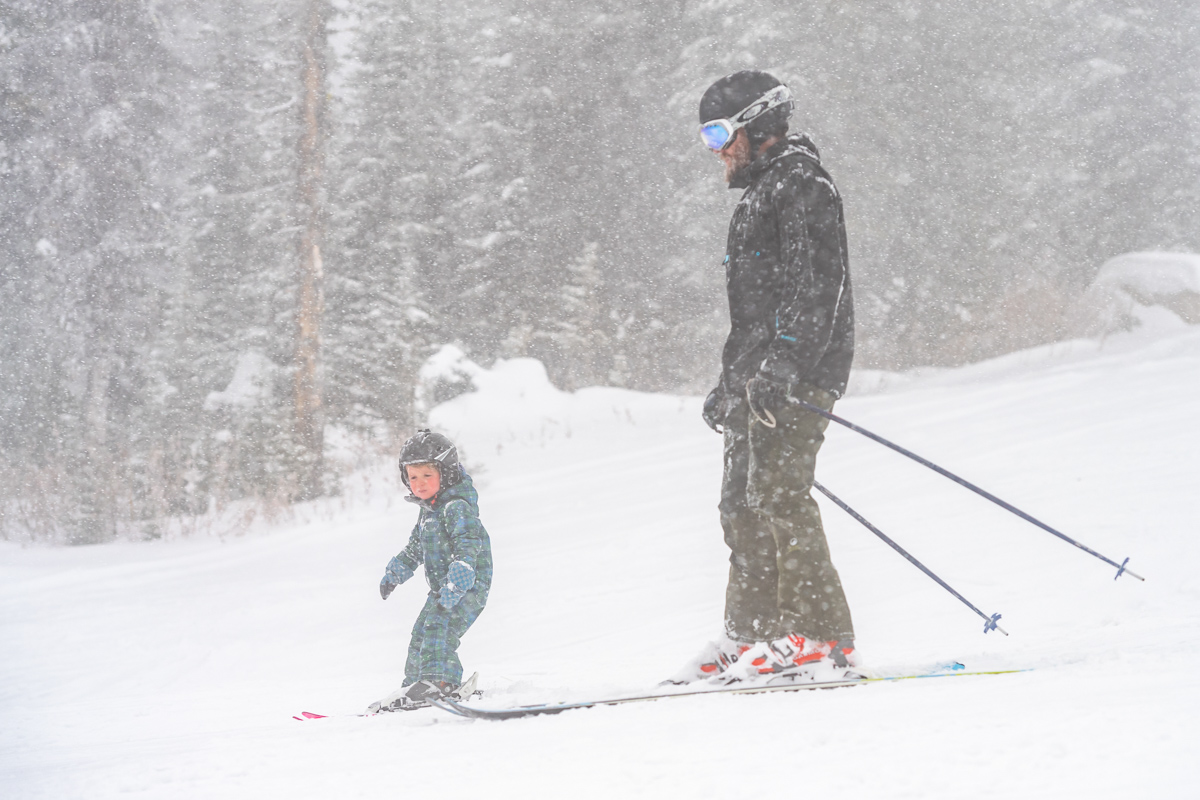 child and parent skiing