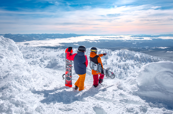 two people snowboarding